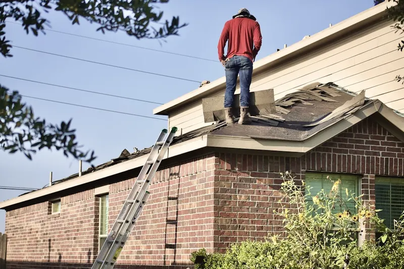 Professional roofer working on a residential roof in West Mahopac